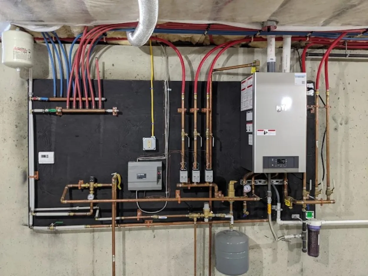 Completed heating system installation with boiler and copper piping